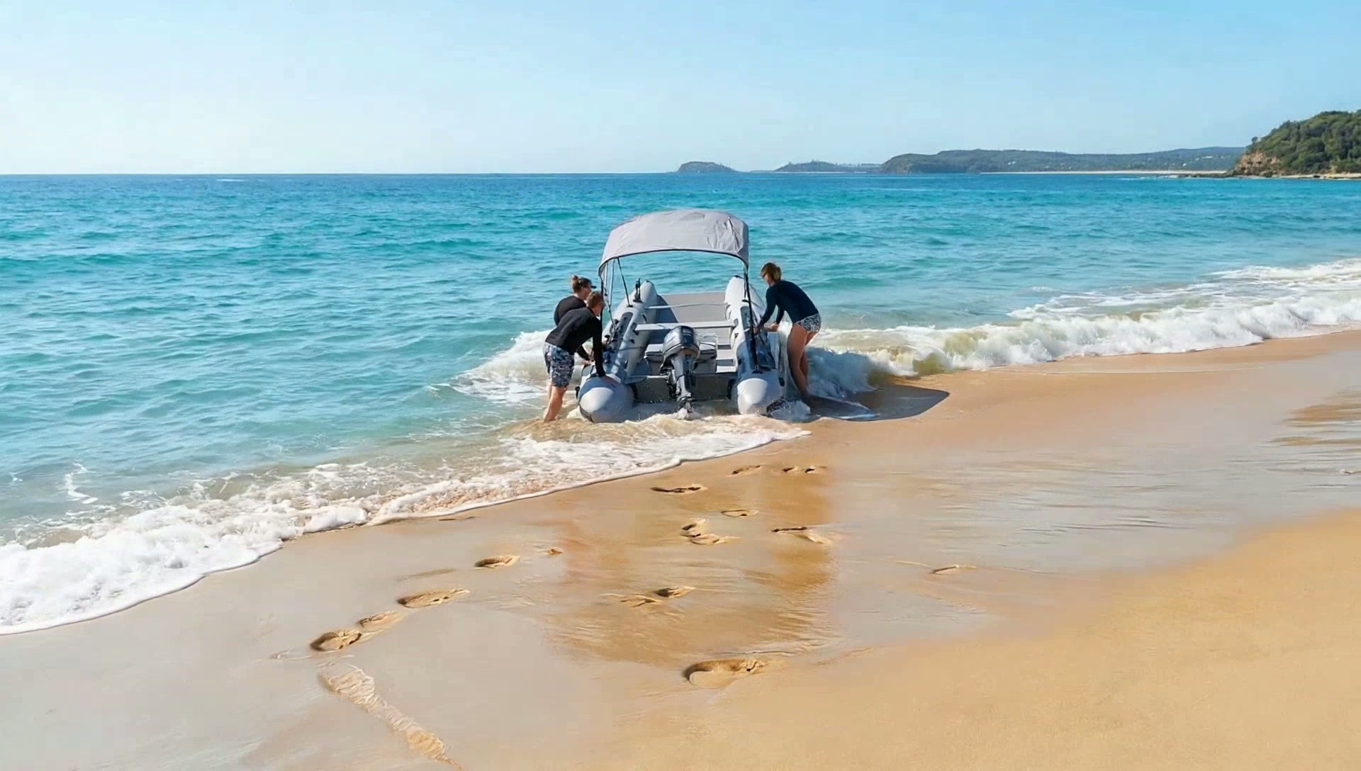 An Aerowave Viper 365 being launched by hand from a sandy beach